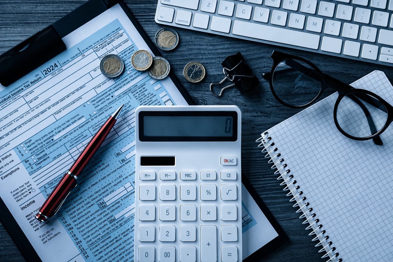 Tax payment plan documents and binder on desk representing IRS debt relief services in Plano
