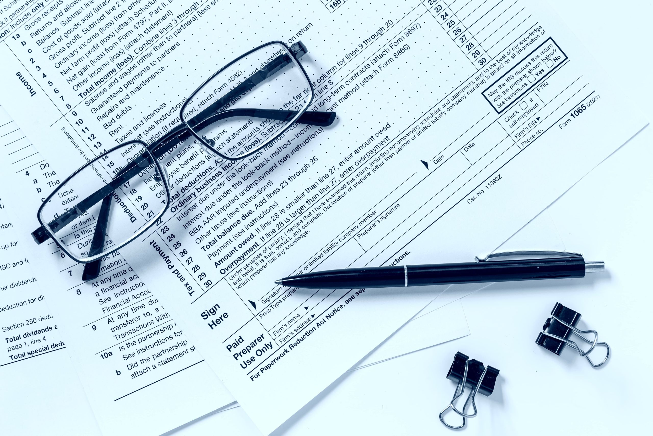 Tax forms and clipboard on desk representing IRS debt relief services in San Antonio