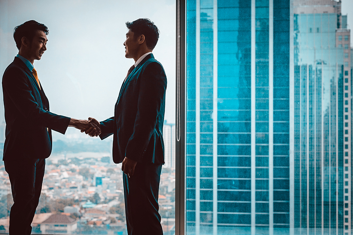 Tax attorney and client reaching IRS debt relief agreement in Rochester