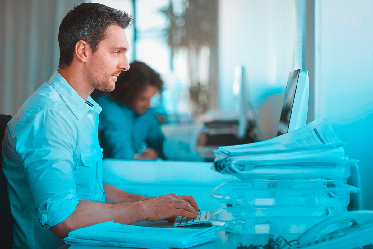 Tax professional reviewing financial software on computer for IRS debt relief services in Rochester