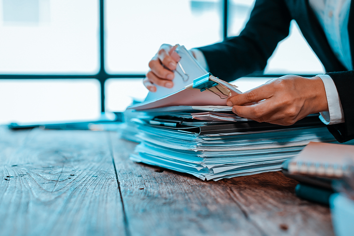 Tax paperwork and filing folders on desk for IRS debt relief services
