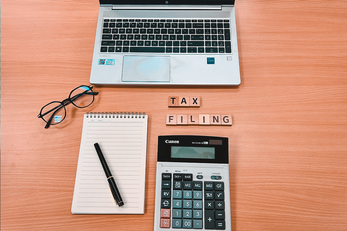 Accountant calculating taxes on computer for IRS debt relief services