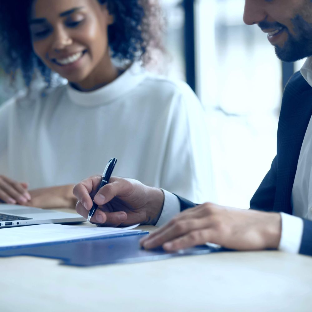 Client signing IRS Installment Agreement with tax attorney to pay tax debt in manageable monthly payments